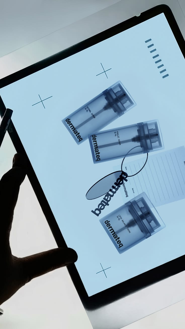 A hand holds a cool blue illuminated product contact sheet with skincare bottles, glasses and editorial markings.