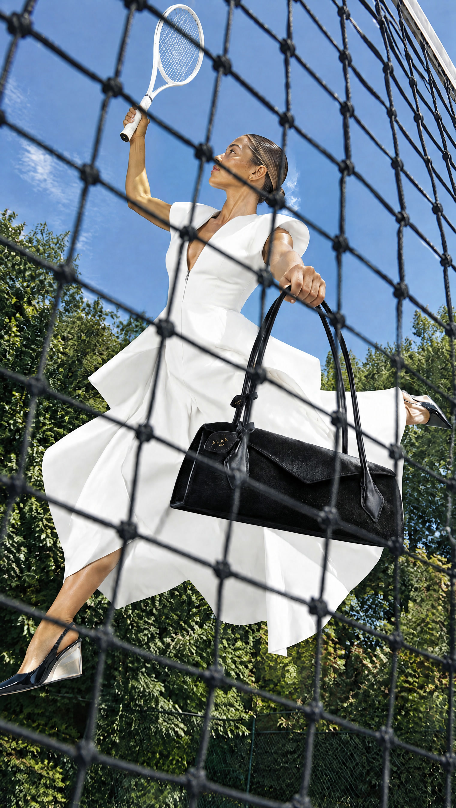 AI fashion concept: white sculptural dress and black bag seen through a tennis net