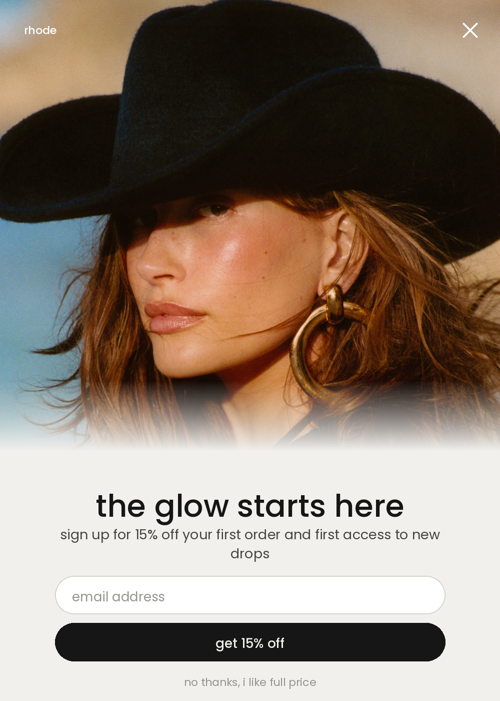 Email sign-up pop-up form with a full-bleed editorial photo on top and a cream panel below with the headline the glow starts here, an email field and a get 15 percent off button