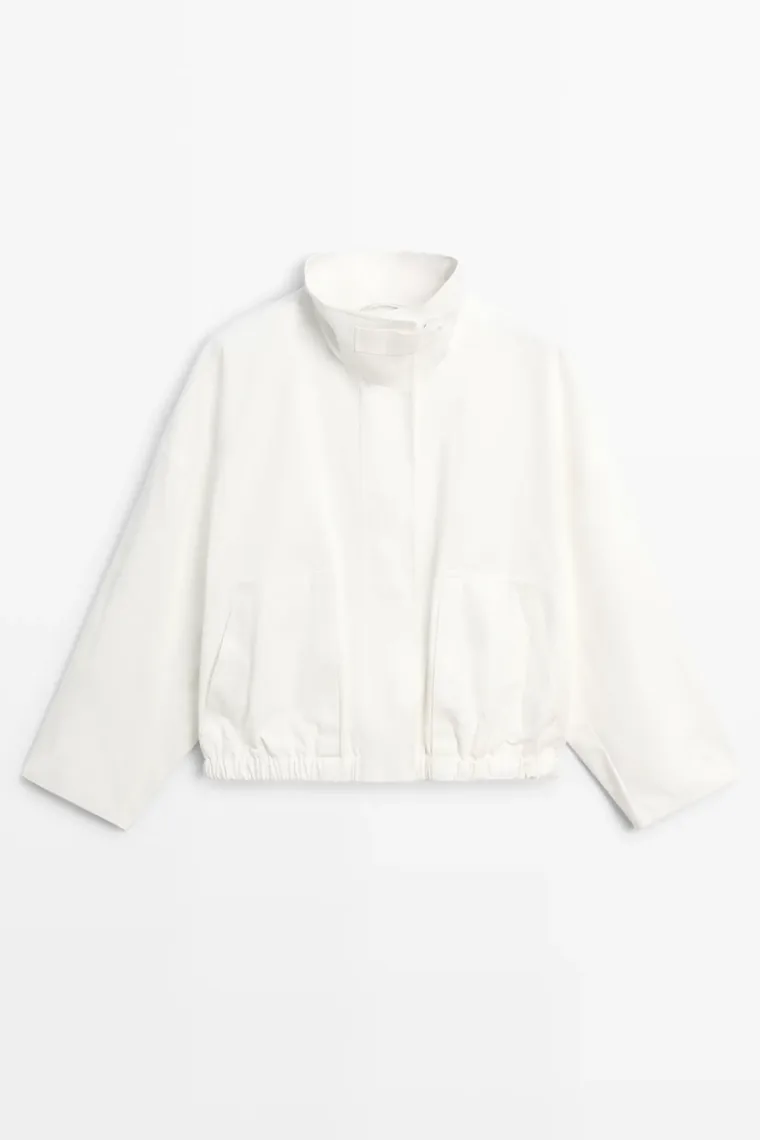 Ivory short boxy jacket with a stand collar and large flap pockets
