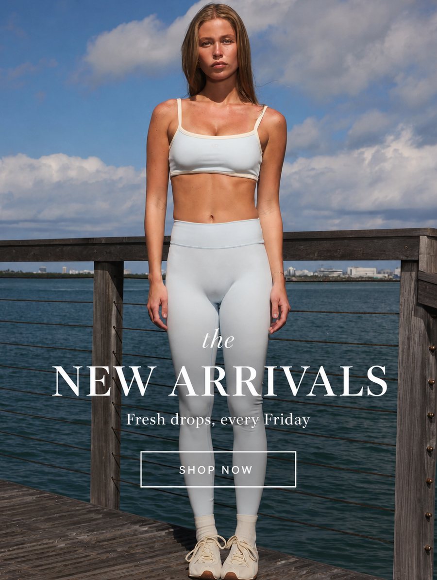 Email banner reading 'the New Arrivals, Fresh drops every Friday' over a lifestyle photo of a model in light blue activewear standing on a wooden pier