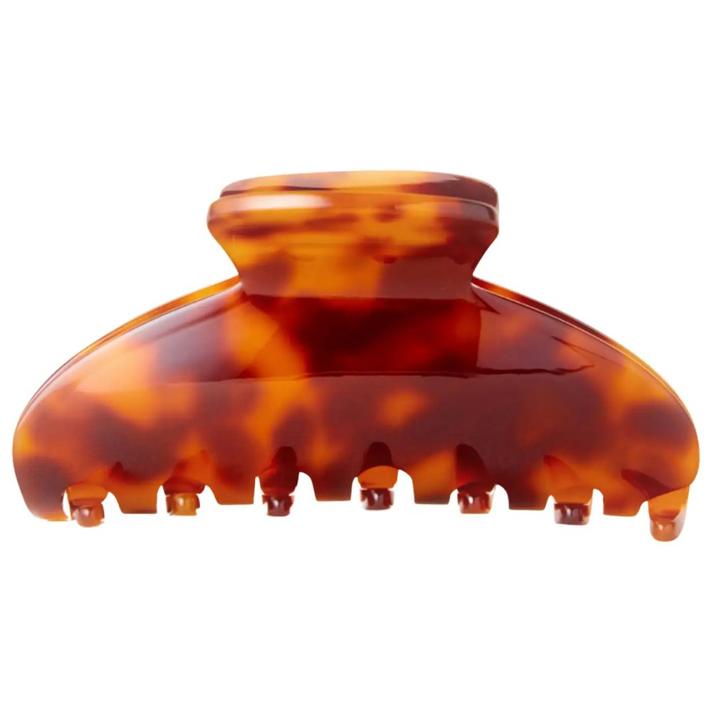 A single tortoiseshell claw clip photographed straight on against a plain white background