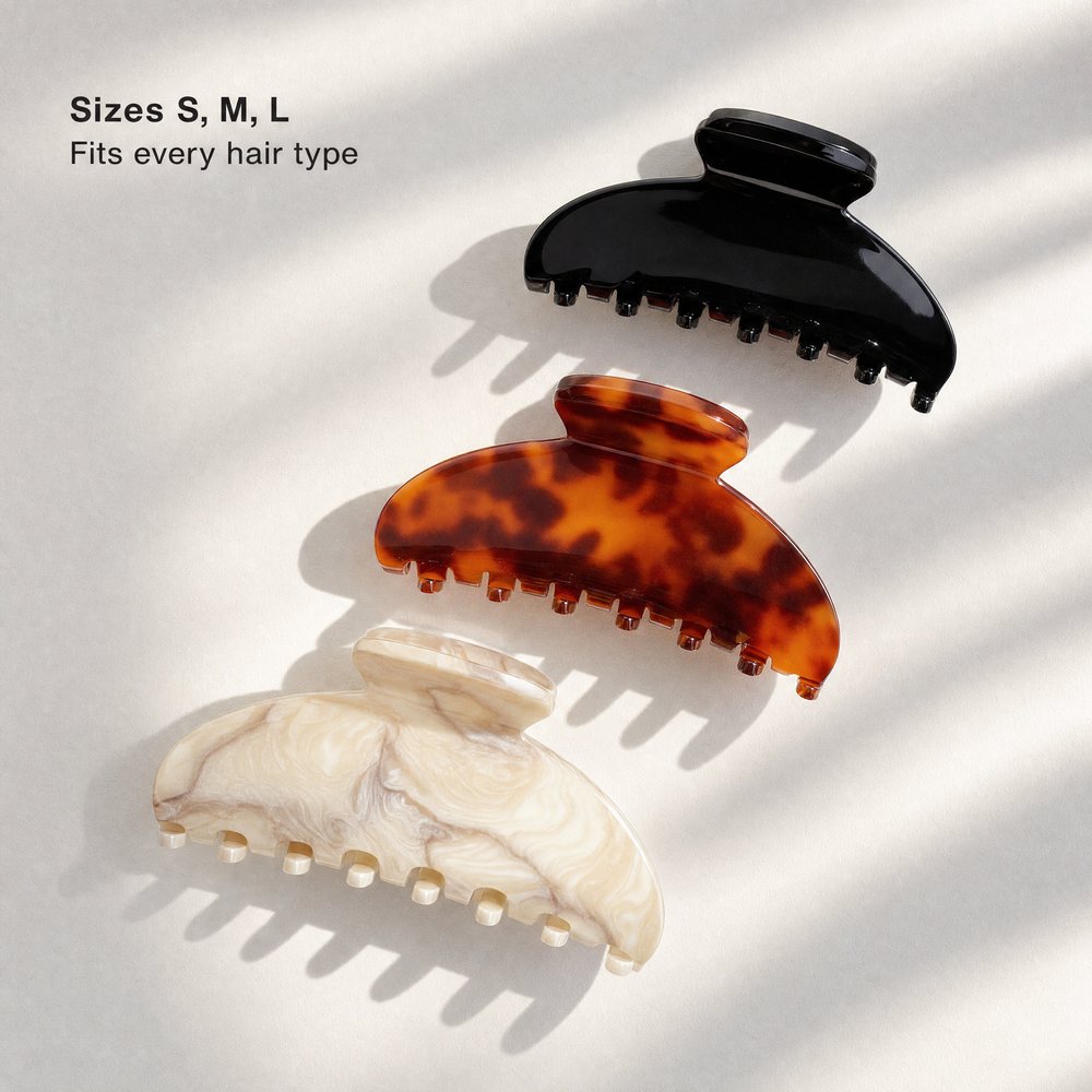 Three claw clips in black, tortoiseshell and cream marble arranged in a diagonal on white, with overlaid text reading Sizes S, M, L